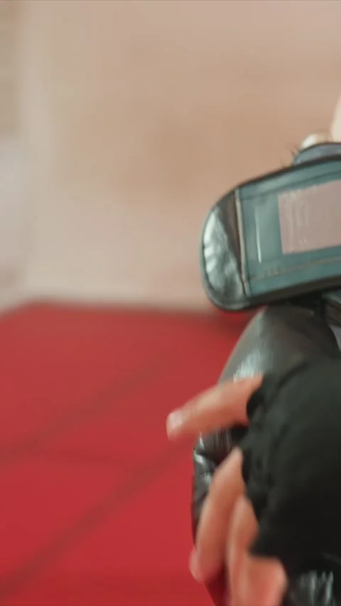 Close up of gloved hands punching and pressing on padded surfaces in gym with Stock Footage 343082526