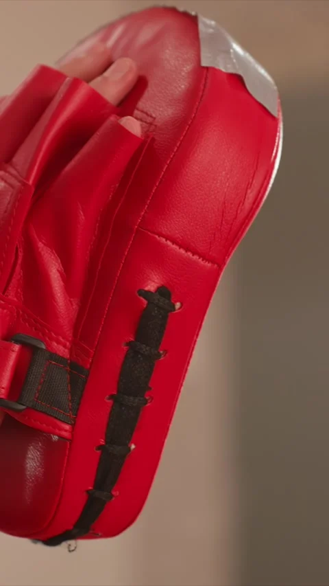 Close up of gloved hands striking red boxing gloves with rapid punch blur on Stock Footage 343082071