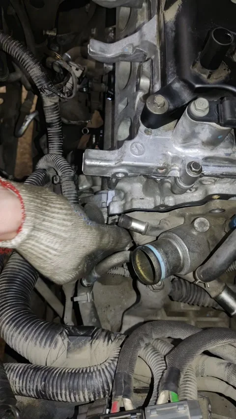 Close-up of gloved hands tightening a bolt on car engine Stock Footage 332240786