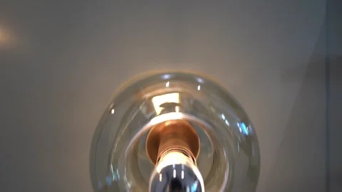 Close-Up Glow: Light Bulb Ignites in the Dark Stock-Footage 310036672