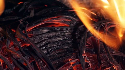 Close up of glowing ashes, flames and smoke from burnt palm leaves Stock-Footage 106455648