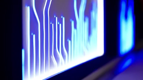 Close-up of glowing blue digital equalizer bars on a modern screen, featuring Stock Footage 325671457