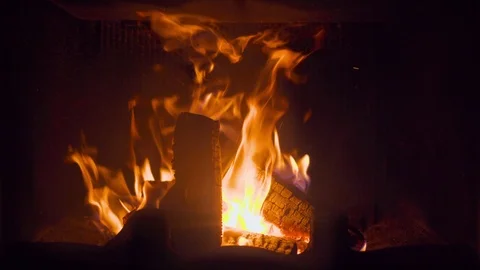 Close-up of glowing burning in fireplace log covered by flame fire Vídeos de archivo 101539700