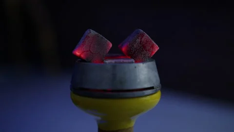 Close-up of the glowing coals of a hookah on a dark background Stock Footage 204842887