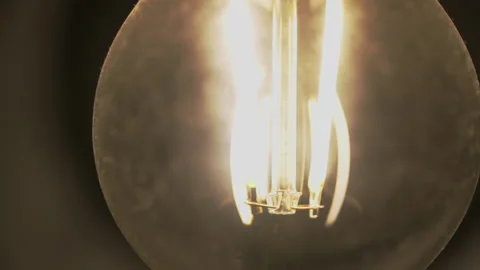 Close up the glowing element of a bulb in a lamp Stock Footage 162477962