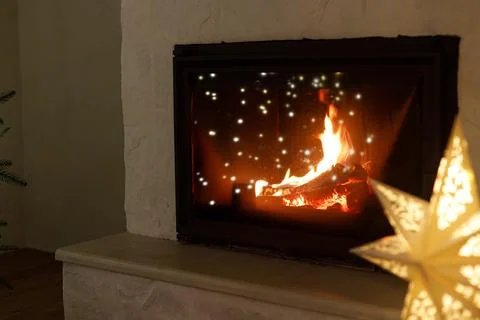 Close Up of Glowing Fireplace with Star Lantern Light. Winter Cozy Holiday .. Stock Photos