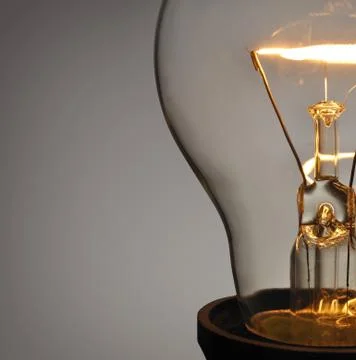 Close up glowing light bulb Stock Photos