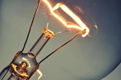 Close up glowing light bulb Stock Photos