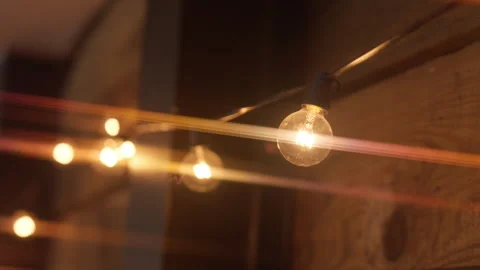 Close-up of glowing light bulbs with anamorphic effect Stock Footage 241203937