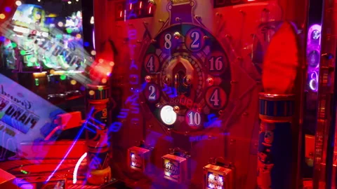 Close-up of a glowing mechanical arcade redemption wheel game with brigh Dave-28 Stock Footage 339533081