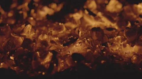 Close-up of glowing red coals in slow motion Video stock 159982655