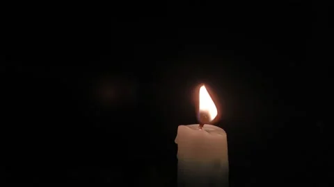 Close-up glowing red fire of a candle during the horror night of halloween. 스톡 동영상 211817624