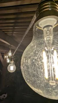 Close-up of a glowing string light bulb at night Stock Photos