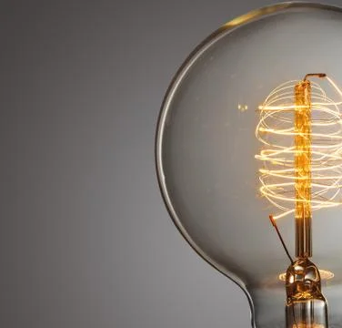 Close up glowing vintage light bulb Stock Photos