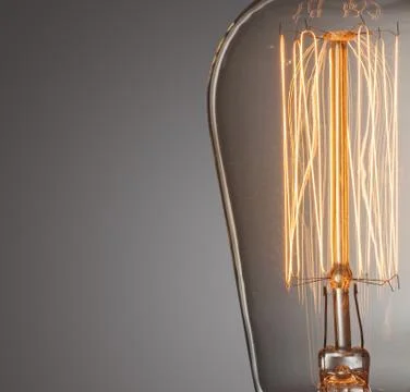 Close up glowing vintage light bulb Stock Photos