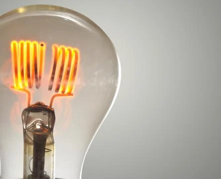 Close up glowing vintage light bulb Stock Photos