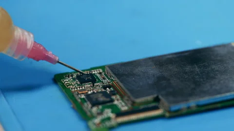 Close up of glue getting put onto the microcircuit Stock Footage 149677793