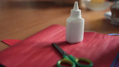 Close up of glue, scissors and colour paper on table Stock Footage 151105089