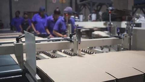 Close up of a gluing machine being stacked with cardboard in a packaging Video stock 105325852