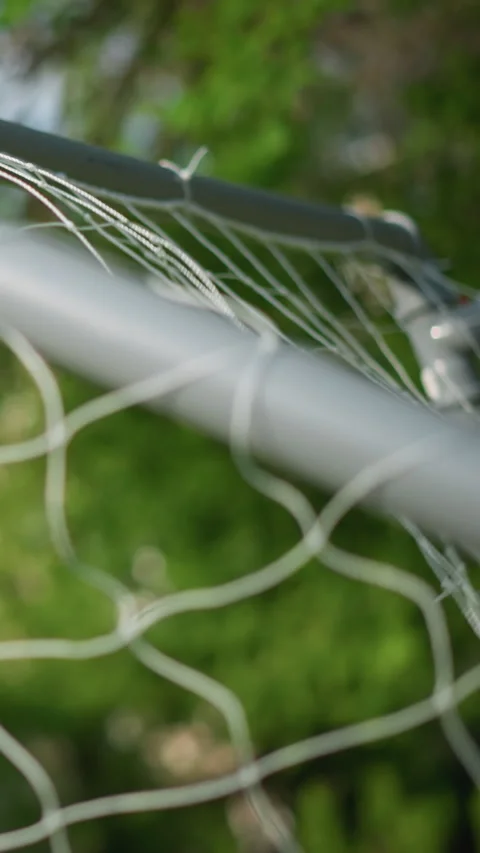 Close-Up of Goal Post as Ball is Shot into the Net, Goalkeeper Misses Stock Footage 309818997