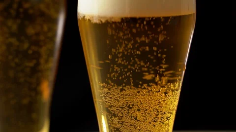 Close-up of goblets with pouring beer isolated Stock Footage 129239410