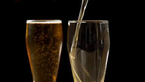 Close-up of goblets with pouring beer isolated Stock Footage 129239414