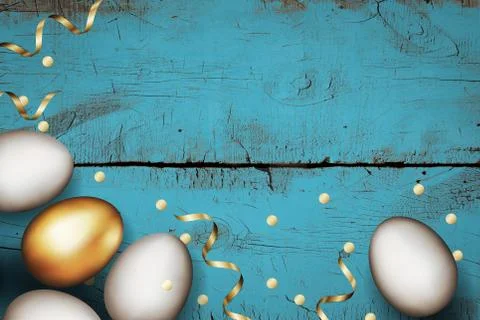 Close up of gold and white easter eggs on painted wooden blue background Stock Photos