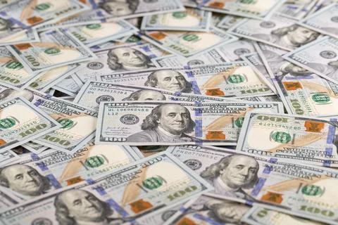 Close Up Gold Bar Shaped Like US One Hundred Dollar Bill on Scattered Cash .. Stock Photos