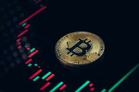 Close up of gold bitcoin on trading graph monitor with selective focus Stock Photos
