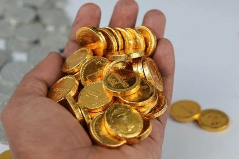 Close up of gold coins stack in hands. Stock Photos