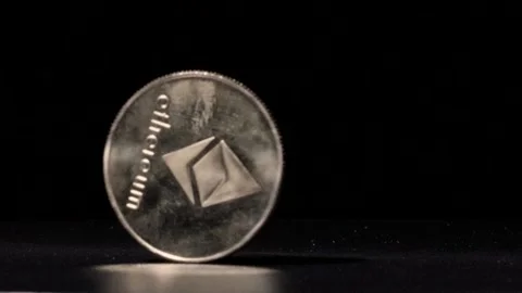 Close up Gold Ethereum spinning in slow motion against black background Stock Footage 217947262
