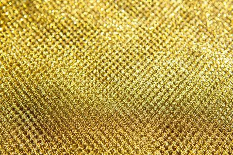 Close-up gold glitter texture background with sparkling metallic pattern and Stock Photos