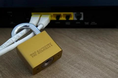 Close-up of gold security padlock on network cables Stock Photos