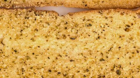 Close up of golden brown cornbread with visible corn kernels and herbs Stock Photos