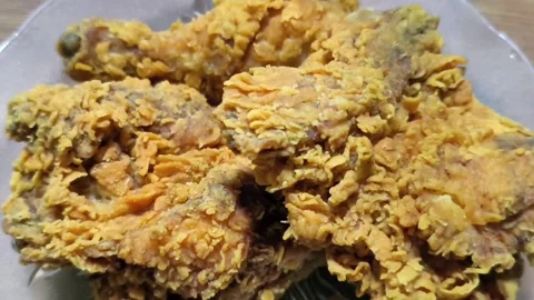 Close-up of golden crispy fried chicken pieces on a plate Stock Footage 329722734