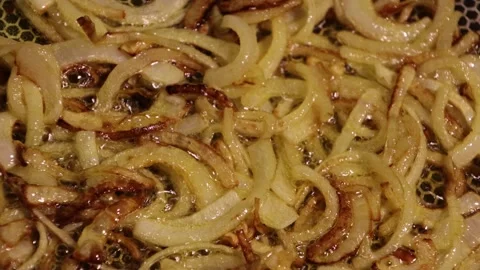 Close-Up of Golden Crispy Fried Onion Rings in Hot Oil Stock Footage 296700964