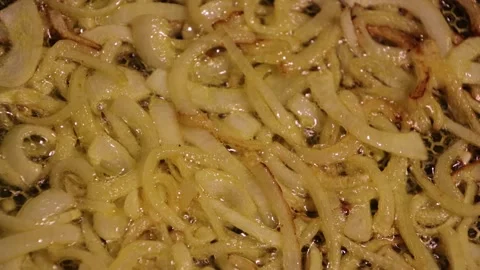 Close-Up of Golden Crispy Fried Onion Rings in Hot Oil Stock Footage 299993036