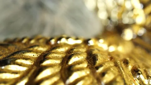 Close up of a golden decorative object showing intricate details and texture Stock Footage 328589328