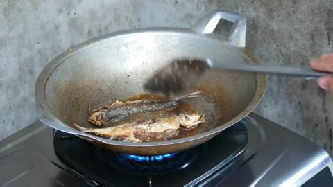 Close-up of golden dried fish fried in boiling oil in a traditional wok Stock-Footage 323723955