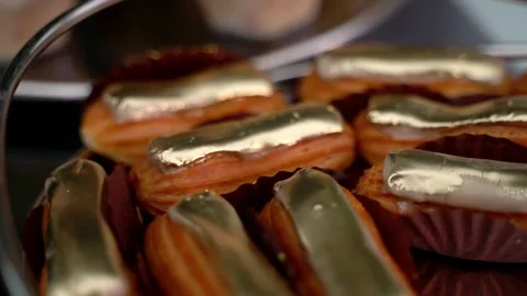 Close up golden eclairs Stock Footage 261151224