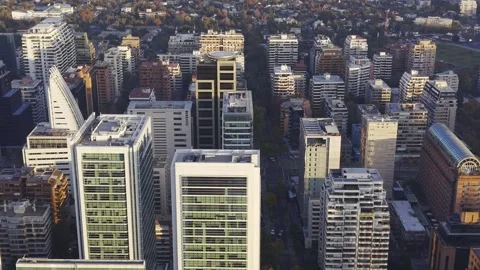 Close golden hour drone slide above Apoquindo office towers Santiago Chile Vídeos de archivo 334683152
