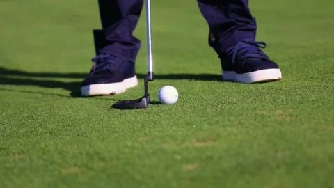 Close-up of a golf ball being hit by a putter on the golf course Stock Footage 292017426