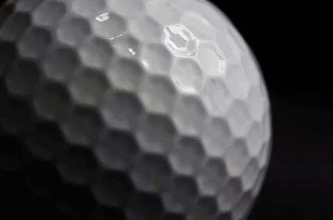 Close up of a Golf ball on black background Stockfoto's