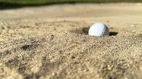 Close Up on a Golf Ball Falling in the Sand Trap in a Sunny Day 動画素材 264476311