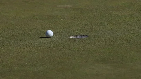 Close Up of Golf Ball Going into Hole on Green Video stock 138675793