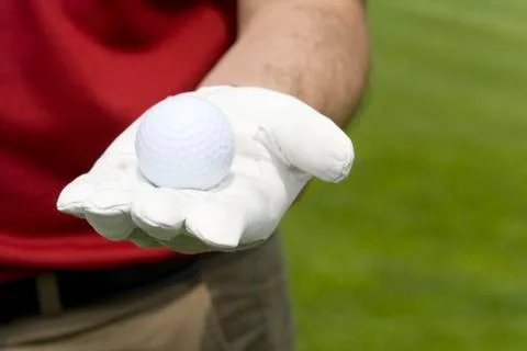 Close-up of a golf ball in hand Stock Photos