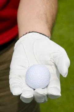 Close-up of a golf ball in hand Stock Photos