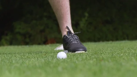 Close up of a golf ball on a tee being hit by a driver Stock Footage 85168880