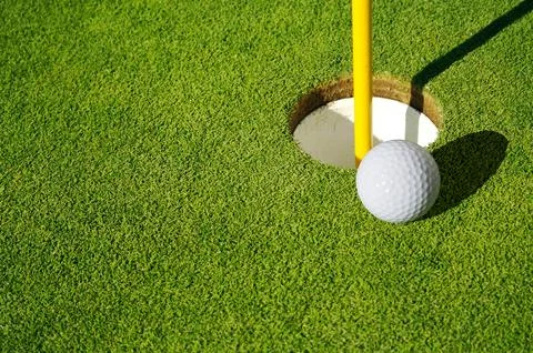 Close-up of Golf Course Green, Flag Pin and Ball. Stock Photos