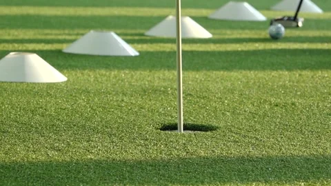 Close-up of a golfer practicing putting on artificial turf with a golf club and Stock Footage 332133851